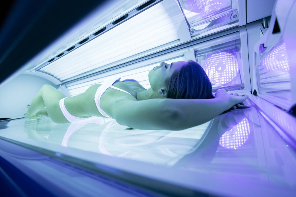Beautiful woman tanning in solarium